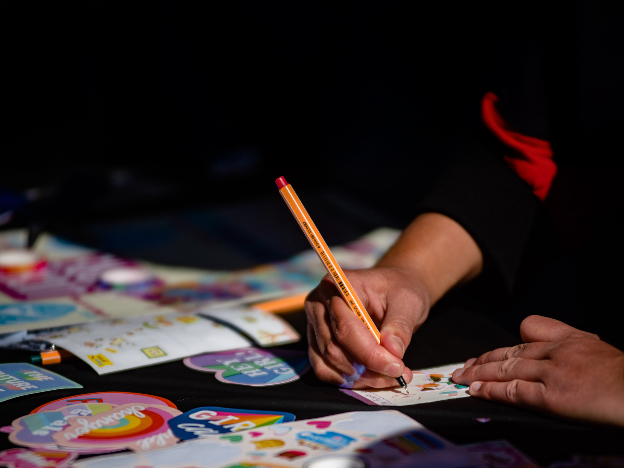 hand with pen and stickers